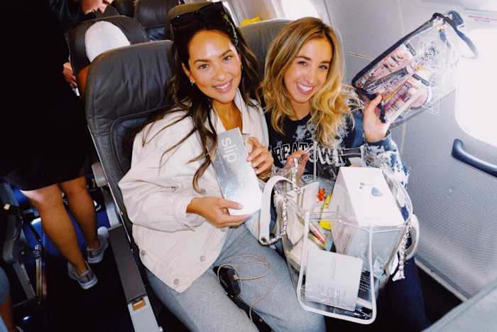 Christen Harper and Katie Austin going through their gift bags.